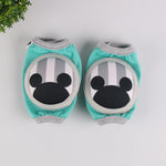 Pair of baby knee pads with green and orange animal print design